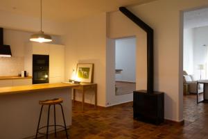 a kitchen and living room with a wood stove at Casa Pina in Galaroza