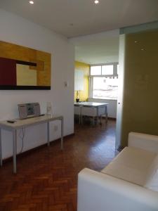 a living room with a couch and a table at ALBERTO DE CAMPOS 66 in Rio de Janeiro