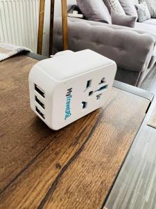 a white router sitting on a table in a living room at East Central London -Studio in London