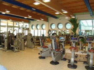 a gym with many treadmills and elliptical machines at Bungalow Chalet sulla Spiaggia in Chioggia