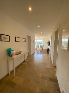 a living room with a table and a hallway at Ferienwohnung Bergblick Wangen im Allgäu mit Garten, 2022 komplett renoviert in Wangen im Allgäu