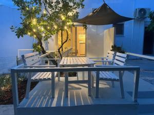 a table and two chairs with an umbrella at Cozy Studio the original in Chalkida