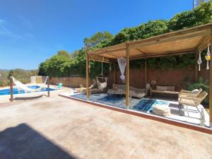 a swimming pool with a pavilion next to a pool at AMIRA home near Sitges in Sant Pere de Ribes