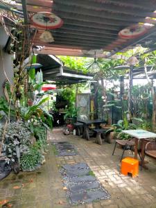a patio with a bunch of plants and a table at Art Villa in Alor Setar
