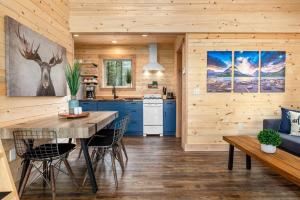 a kitchen and living room with a table and chairs at One of a kind views of GNP - Cabin 2 in Polebridge