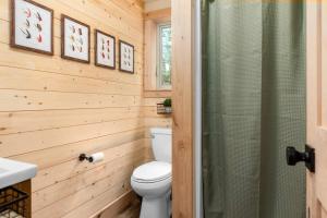 a bathroom with a toilet and a shower at One of a kind views of GNP - Cabin 2 in Polebridge