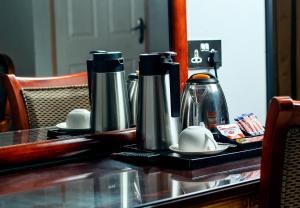 a table with two kettles on top of it at Dolar Lodges & Tours in Maun