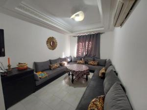 a living room with a couch and a table at Joy Lodge in Marrakech