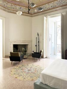 a bedroom with a bed and a fireplace at Roiss Haus Suites in Lecce