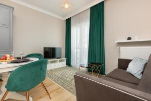 a living room with a couch and a table at Wola Beautiful Pet-Friendly Apartment by Renters in Warsaw