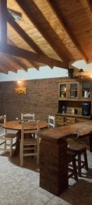 a kitchen with a wooden table and some chairs at La Bellota in Villa Ventana