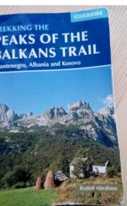 a book about the peaks of the alps trail at Peaks of the Balkans Trail 192 km -- Hostel Panorama -- in Peje