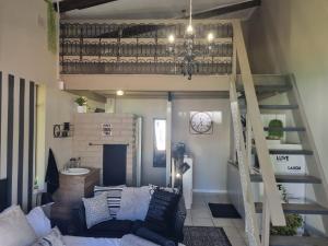 a living room with a loft bed and a staircase at Angel 8 AirBnB Apartment 2 in Robertson