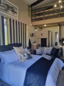 a large blue bed with pillows on top of it at Angel 8 AirBnB Apartment 2 in Robertson