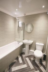 a bathroom with a toilet and a sink at Entire 2 Bed Apartment in Manchester in Manchester