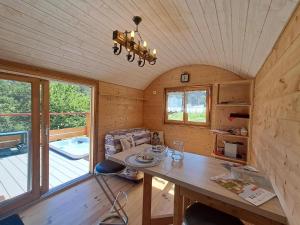 a small room with a table in a tiny house at La roulotte du tonnelier in Castelnau-de-Montmiral