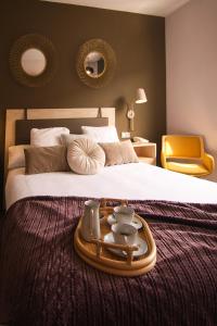 a hotel room with a bed with a tray on it at HOTEL MAUROS EL PUIG in El Puig