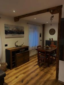 Casa Rodi في Siror: غرفة معيشة مع طاولة خشبية وغرفة طعام