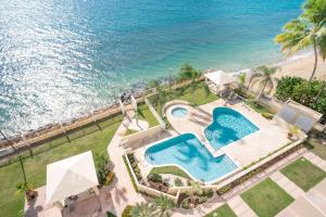 an overhead view of a swimming pool and the ocean at Beachfront 5th floor at Pelican Reef in Rincon