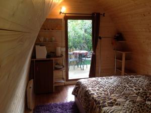 a bedroom with a bed and a door to a patio at Igloo Mobil Home in Soiano del Lago