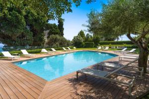 a swimming pool with lounge chairs on a wooden deck at Mon Repos Avenir in Taormina