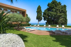 a swimming pool with lounge chairs and a house at Mon Repos Avenir in Taormina +44 photos
