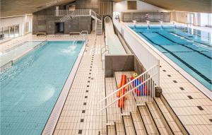 a large swimming pool in a building at Hytte 8 in Thyborøn