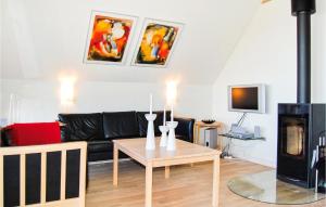 a living room with a couch and a table at Amazing Home In Rm With Wifi in Bolilmark