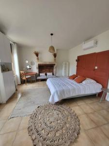 a bedroom with a large bed and a living room at L'OREE DES LACS, Maison de village tout confort in Radonvilliers