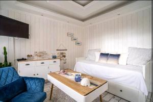 a bedroom with a bed and a table and a chair at Deauville : magnifique studio en face du Casino ! in Deauville