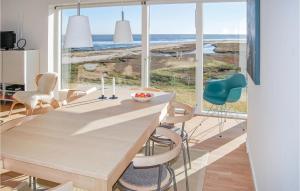 uma cozinha com mesa e cadeiras com vista para o oceano em Beautiful Home In Rm With 4 Bedrooms And Wifi em Rømø Kirkeby