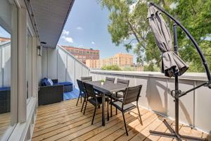 a balcony with a table and chairs and an umbrella at TripMontreal 302 in Montreal