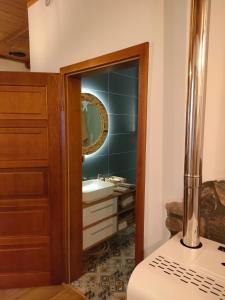 a bathroom with a sink and a mirror at Apartament w Centrum in Żuromin