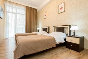 a hotel room with two beds and a window at The Urban Retreat in Tbilisi City