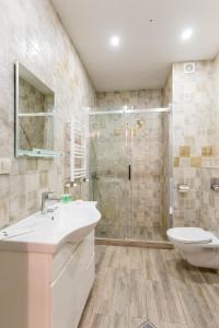 a bathroom with a shower and a sink and a toilet at The Urban Retreat in Tbilisi City