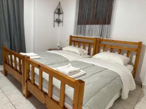 a bedroom with two beds with towels on them at Bacchus Villa in Archea Pissa