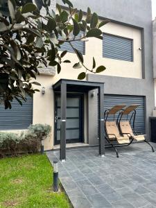 two chairs sitting on a patio in front of a house at Incantevole villa Safi Sidi Bouzid near beach in Safi