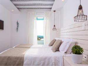 Säng eller sängar i ett rum på Paradise Design Apartments