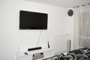 a living room with a flat screen tv on the wall at Professional Studio Appartment in Bobigny
