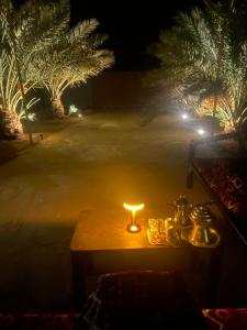 a table with a candle on it at night at Mountain house in Al-ʿUla