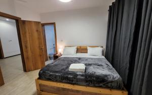 a bedroom with a large bed with a wooden frame at The Manzonia in Tema