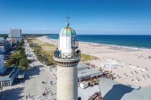 a lighthouse on the beach next to a beach at Weitblick-Loft mit Terrasse in Rostock