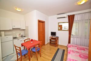 a small kitchen and dining room with a table and chairs at Apartments Bozikovic in Podstrana