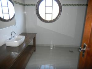 a bathroom with a sink and two windows at Villaggio D'Amore in Monte Verde