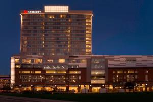 a building with a sign on top of it at night at Buffalo Marriott at LECOM HARBORCENTER in Buffalo
