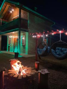 a fire pit in front of a building at night at LaDomita in Camanducaia
