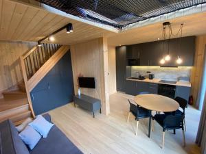a kitchen and a dining room with a table and chairs at Love Wysove in Wysowa-Zdrój +12 photos