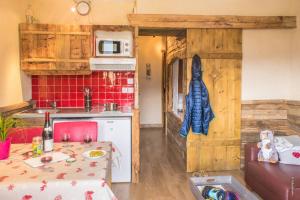 a kitchen with a table and a kitchen with a stove at Zenith Appartements VTI in Val Thorens