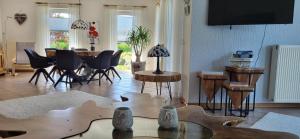a living room with a table and chairs at Ferienhaus Gesine 25193 in Bunde