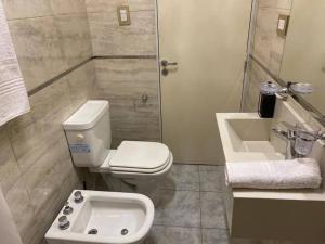 a bathroom with a toilet and a sink and a shower at Departamento Barcelona in Formosa